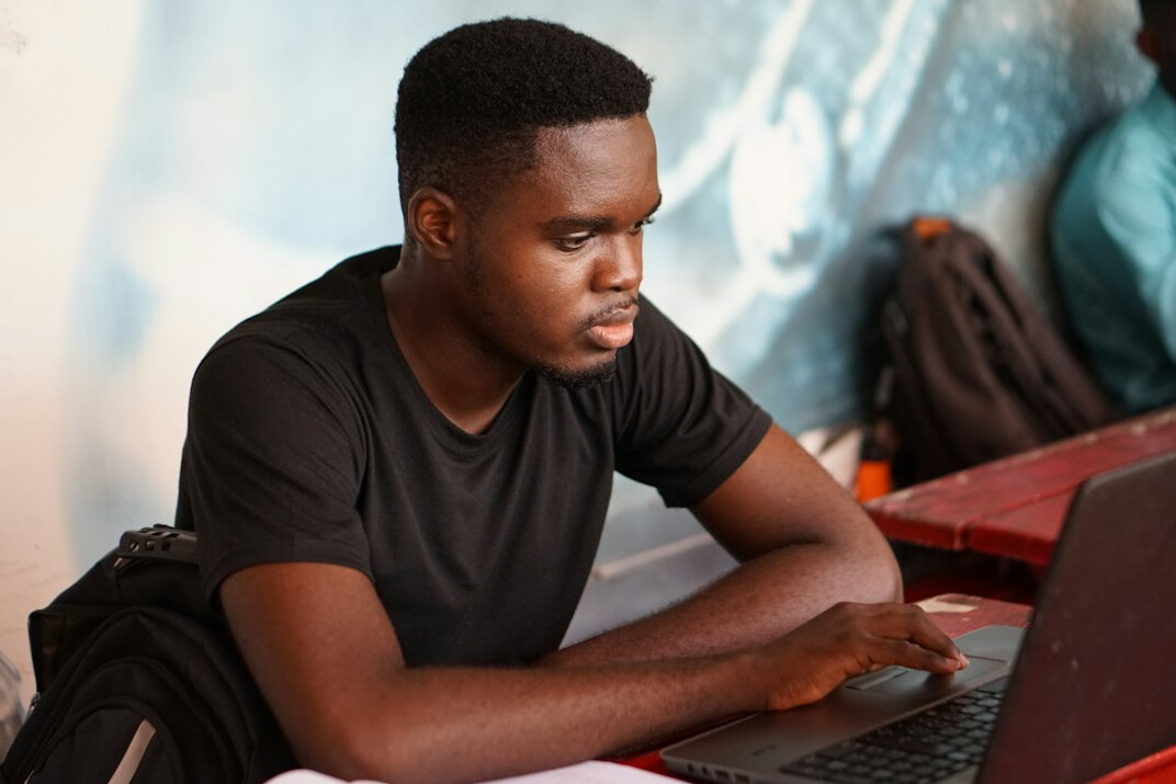young programmer learning on laptop