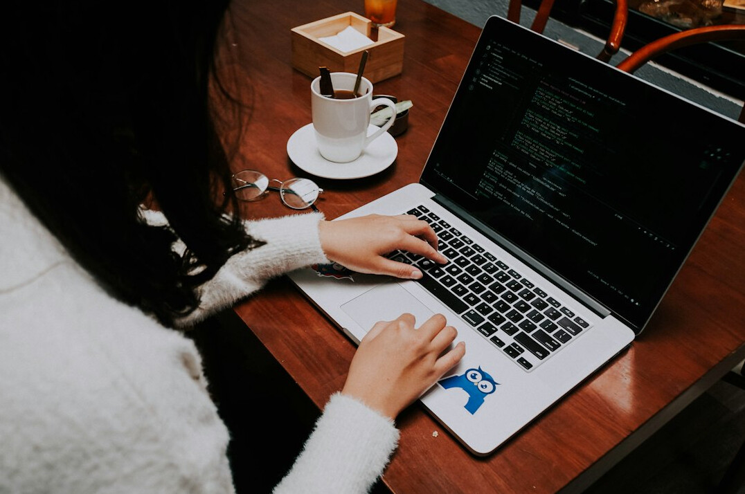 young developer coding on laptop